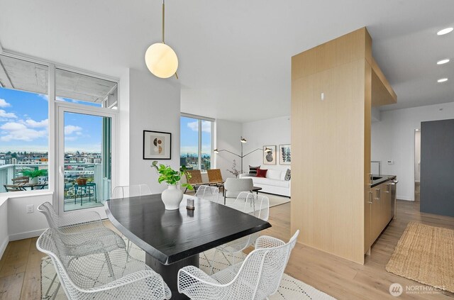 dining room with recessed lighting and light wood-type flooring