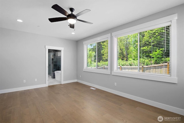 empty room featuring recessed lighting, wood finished floors, baseboards, and ceiling fan