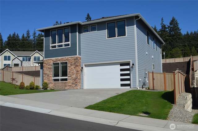 view of front facade featuring concrete driveway, stone siding, an attached garage, and fence