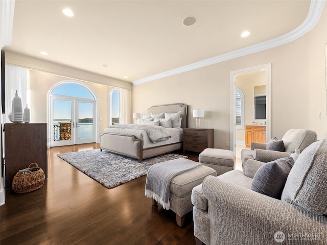 bedroom featuring dark wood finished floors, ornamental molding, recessed lighting, ensuite bath, and access to outside