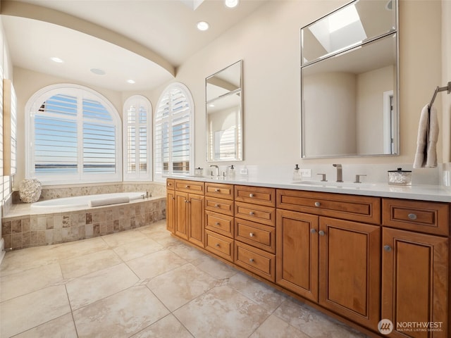 bathroom with a sink, a garden tub, double vanity, and tile patterned floors