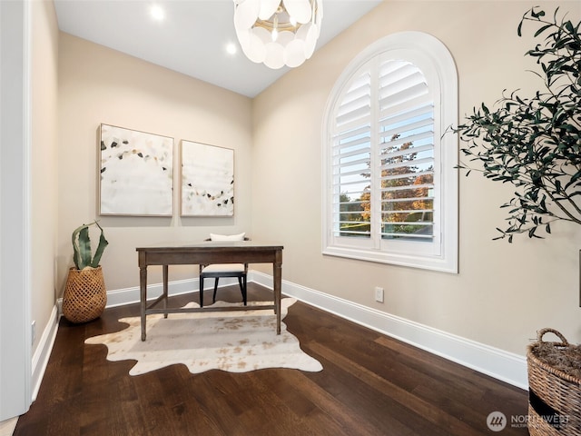 office featuring baseboards, an inviting chandelier, and wood finished floors