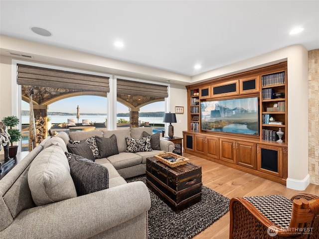 living area with recessed lighting, visible vents, and light wood-style flooring