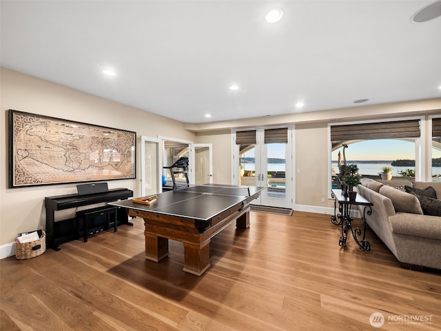 playroom featuring light wood finished floors, recessed lighting, french doors, and baseboards