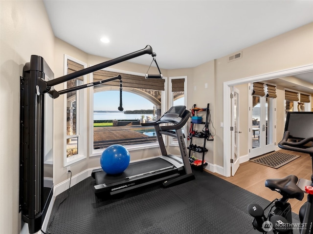 exercise area featuring visible vents, baseboards, recessed lighting, french doors, and wood finished floors