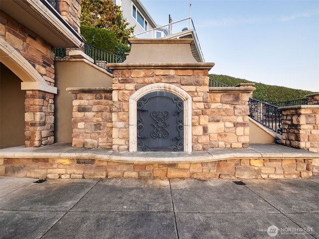 exterior space with stairs and stone siding