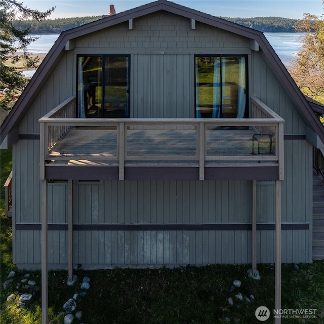 239 Shoreland Dr, Lopez Island, WA 98261 - view of side of home featuring board and batten siding, a balcony, and a water view