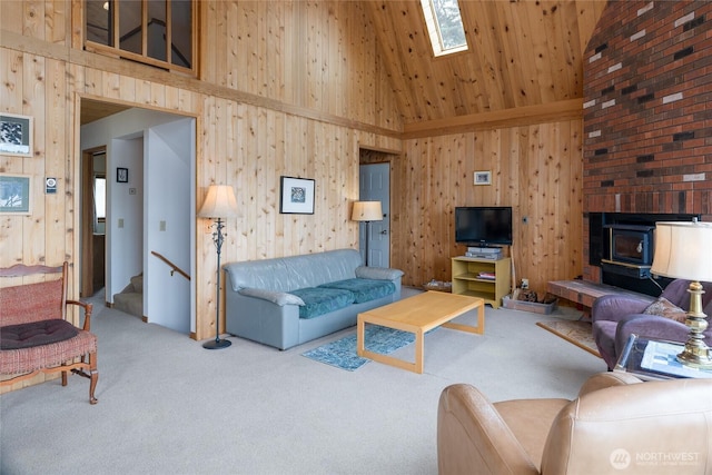 239 Shoreland Dr, Lopez Island, WA 98261 - carpeted living room with wood walls, stairs, a wood stove, and a towering ceiling