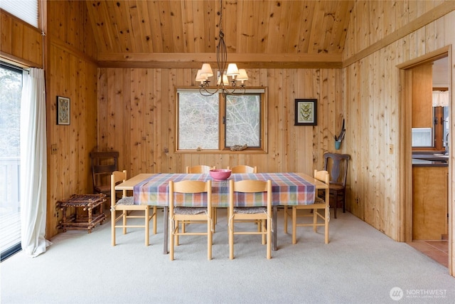 239 Shoreland Dr, Lopez Island, WA 98261 - carpeted dining area with an inviting chandelier, wooden walls, and wood ceiling