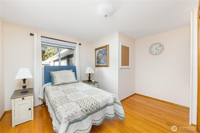 bedroom featuring baseboards and light wood-style flooring