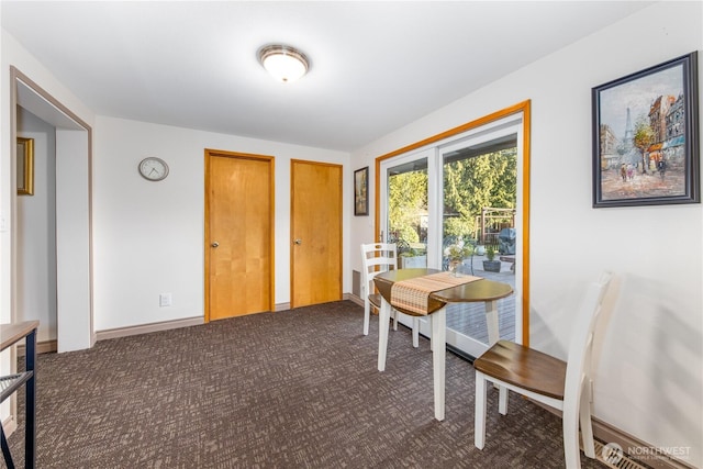 dining room with dark carpet and baseboards