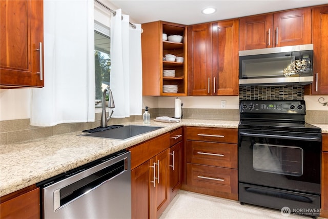 kitchen featuring a sink, light stone counters, open shelves, recessed lighting, and stainless steel appliances