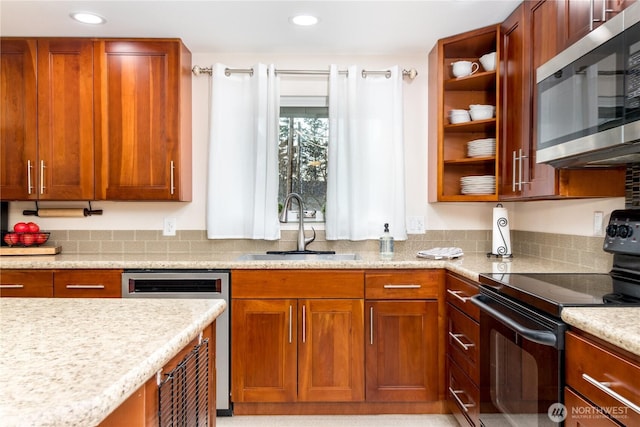 kitchen with a sink, open shelves, recessed lighting, stainless steel appliances, and light countertops