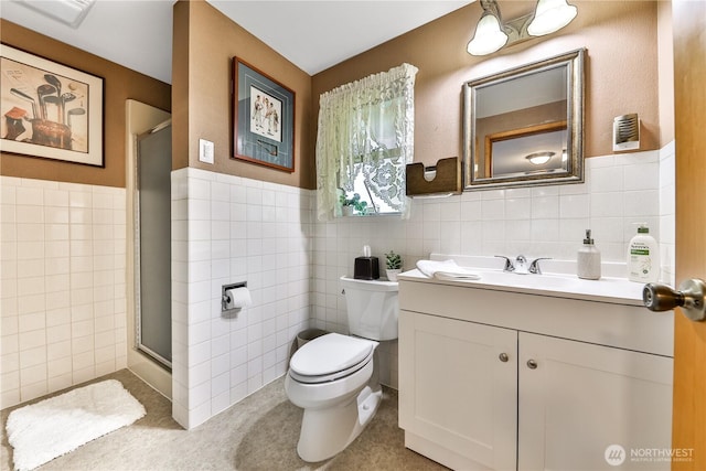 full bath featuring vanity, a shower stall, toilet, and tile walls