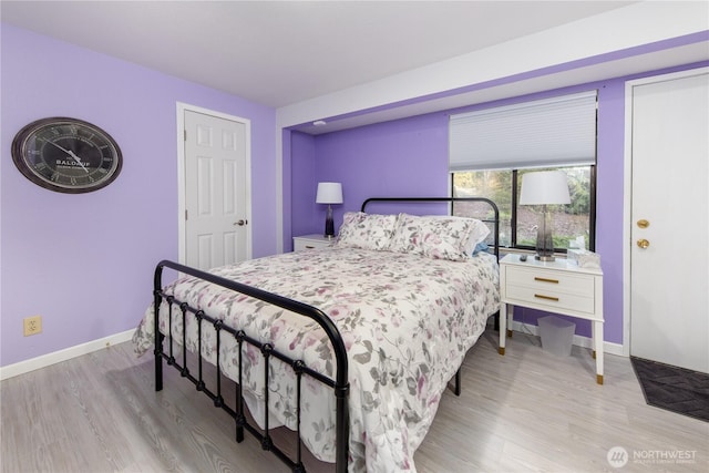 bedroom with baseboards and wood finished floors