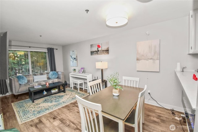 dining area featuring wood finished floors and baseboards