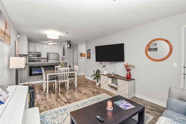 living room featuring baseboards and wood finished floors