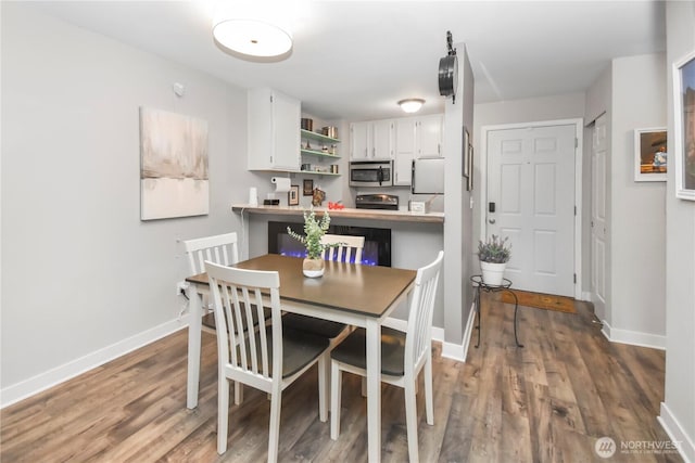 dining room featuring baseboards and wood finished floors