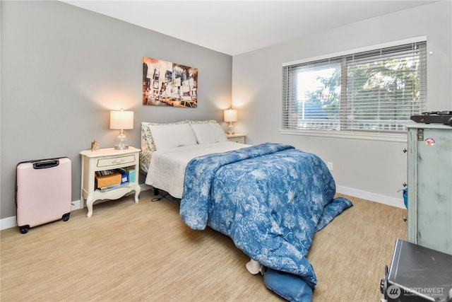 bedroom with baseboards and wood finished floors