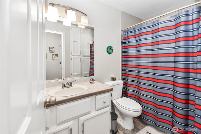 bathroom featuring vanity, curtained shower, and toilet