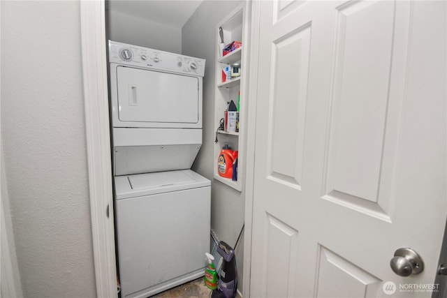 laundry area featuring stacked washer / dryer and laundry area