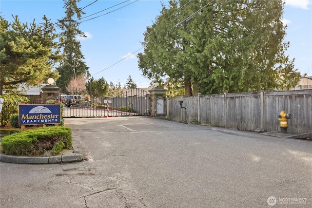 view of road with a gate and a gated entry