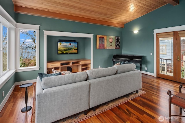 living area with baseboards, wooden ceiling, and hardwood / wood-style flooring