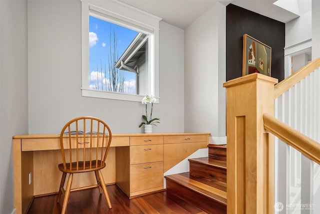 office area with dark wood-style floors and built in study area