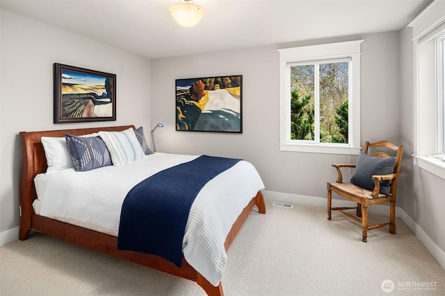 bedroom featuring visible vents, baseboards, and carpet