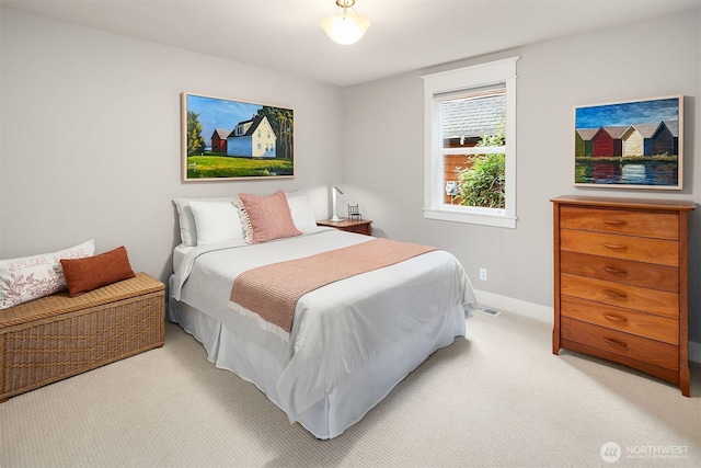 bedroom featuring light carpet and baseboards