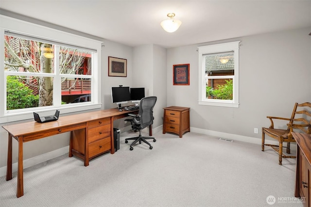 office space featuring visible vents, baseboards, and light colored carpet