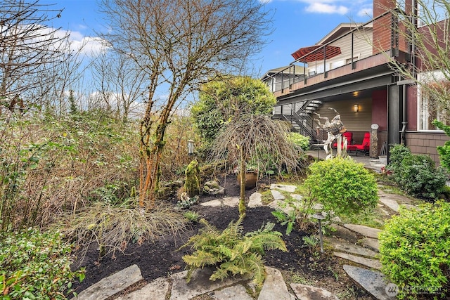 view of yard with a patio area and stairs