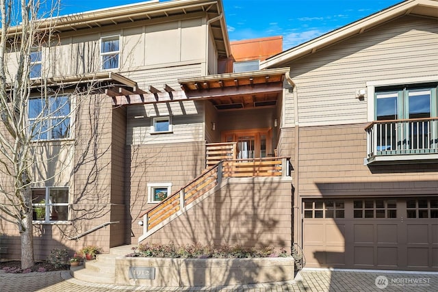 view of front of property featuring a garage and stairs