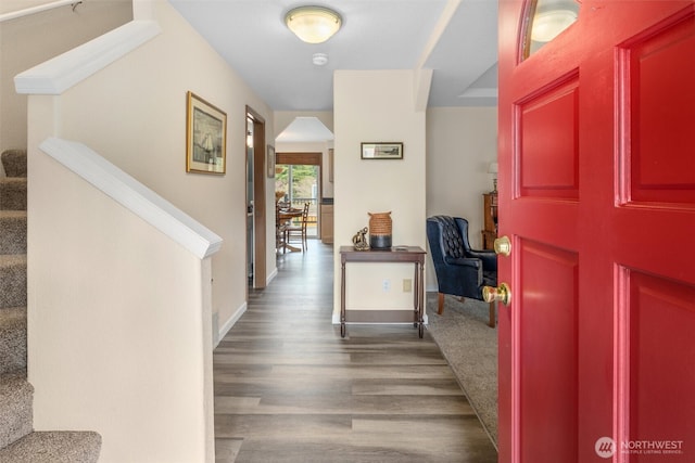 entryway with stairway, baseboards, and wood finished floors