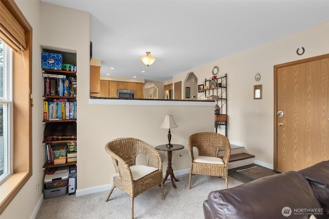 living area with recessed lighting, baseboards, and light carpet