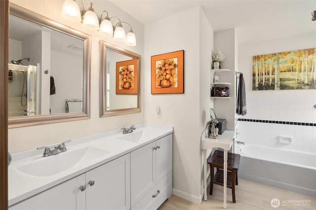 full bath with double vanity, a bathing tub, and a sink