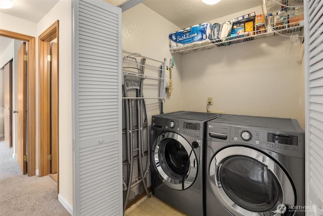 laundry room featuring laundry area, carpet floors, and washing machine and clothes dryer