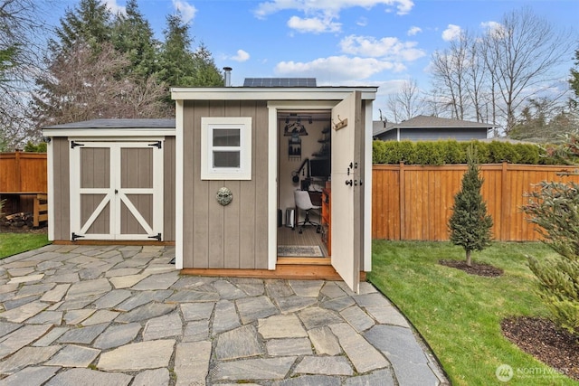 view of shed with a fenced backyard