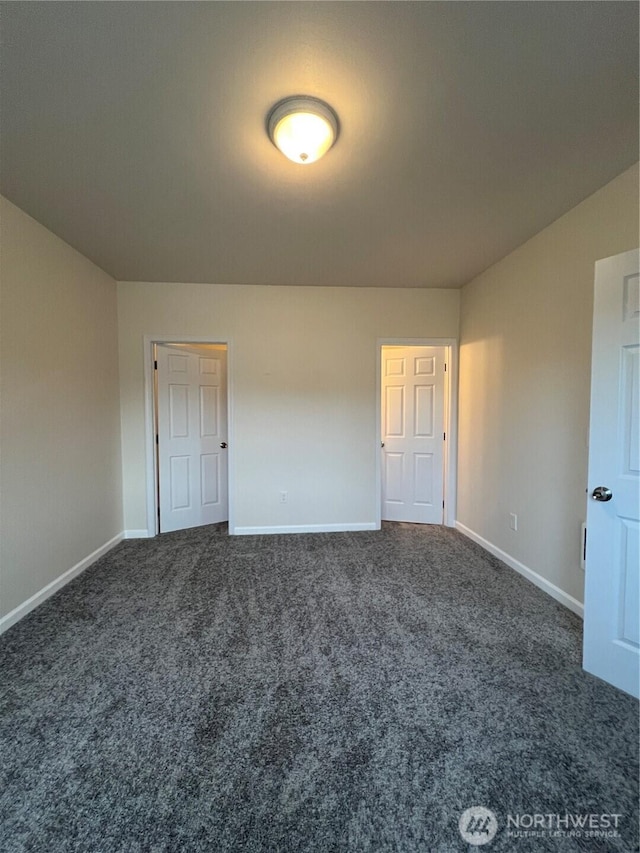 unfurnished bedroom featuring carpet and baseboards