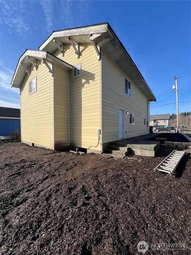 view of side of home with a patio area