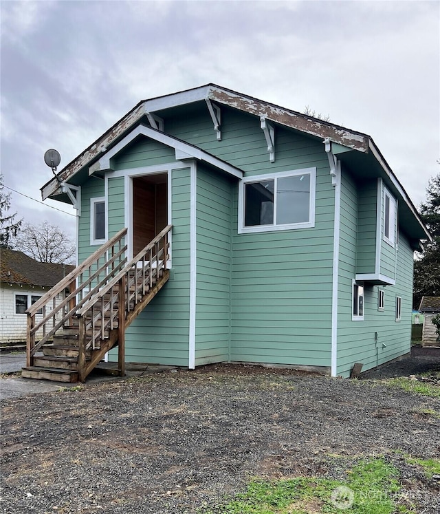 view of front of home featuring stairway and driveway