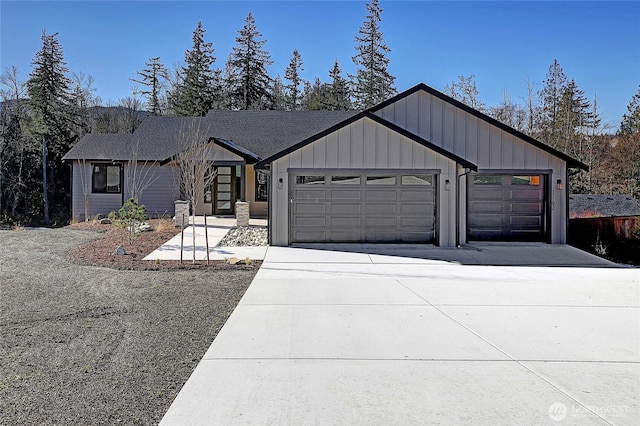 modern inspired farmhouse featuring board and batten siding, concrete driveway, and a garage