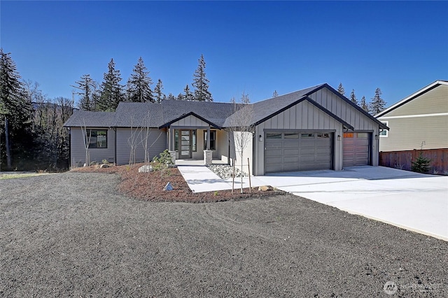 view of front facade with an attached garage, board and batten siding, and driveway