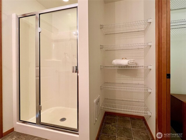 bathroom with visible vents, baseboards, a stall shower, and tile patterned flooring