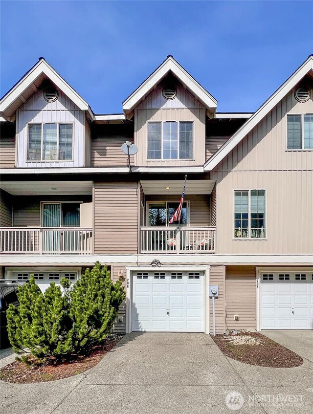 view of property featuring an attached garage and driveway