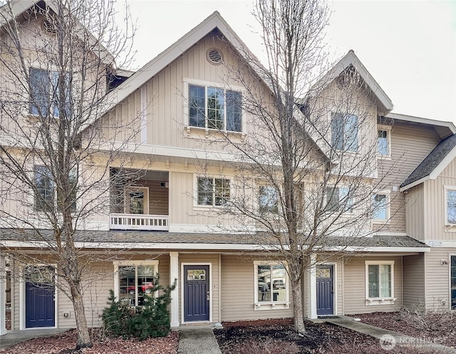 townhome / multi-family property featuring a balcony and board and batten siding