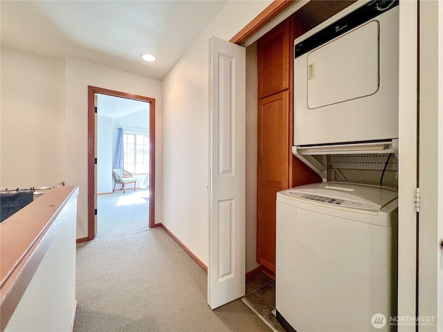 laundry area with baseboards, light carpet, laundry area, recessed lighting, and stacked washer / drying machine