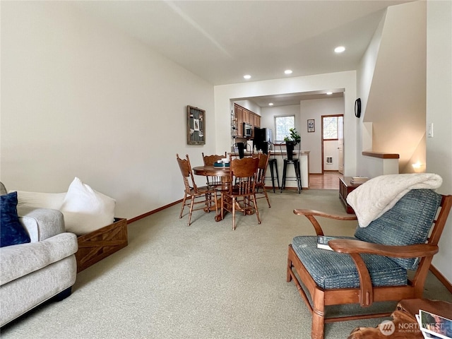 dining area with recessed lighting, light colored carpet, and baseboards