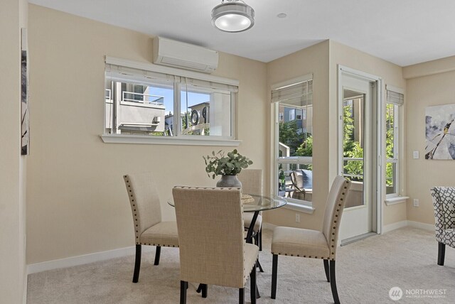 dining space with baseboards, plenty of natural light, an AC wall unit, and carpet