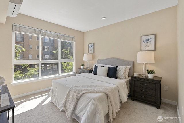 carpeted bedroom featuring a wall mounted air conditioner and baseboards